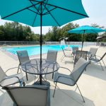 Association swimming pool has outdoor furniture